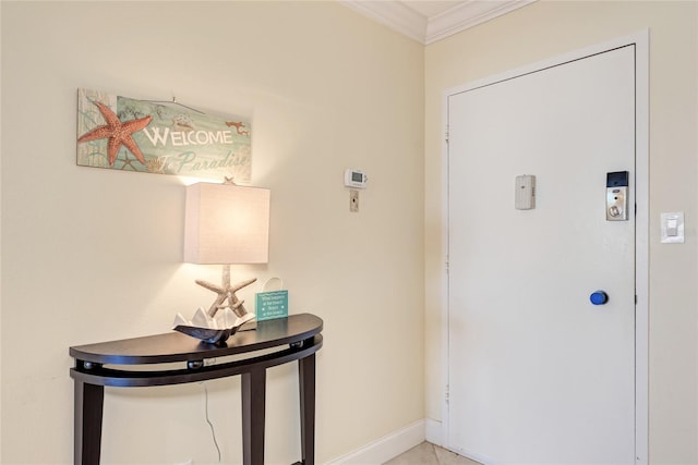 entrance foyer featuring baseboards and ornamental molding