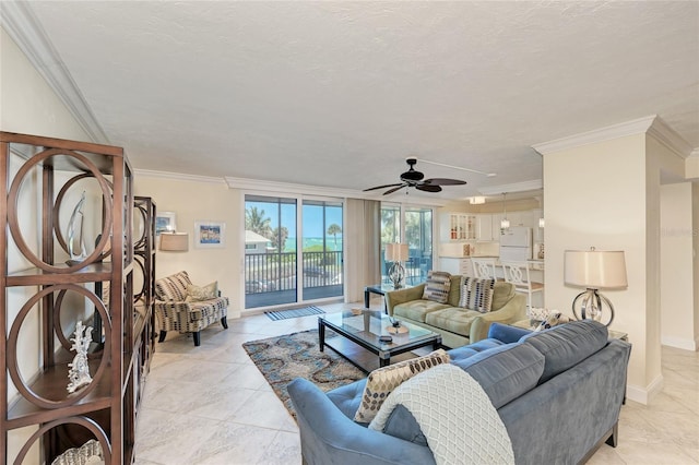 living area featuring light tile patterned floors, a textured ceiling, baseboards, and crown molding