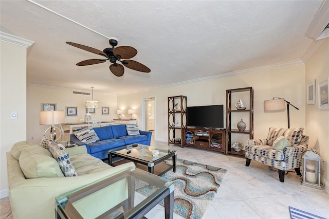 living area with visible vents, crown molding, a textured ceiling, and ceiling fan