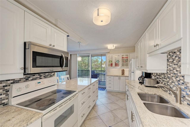 kitchen with white appliances, white cabinetry, decorative backsplash, and a sink