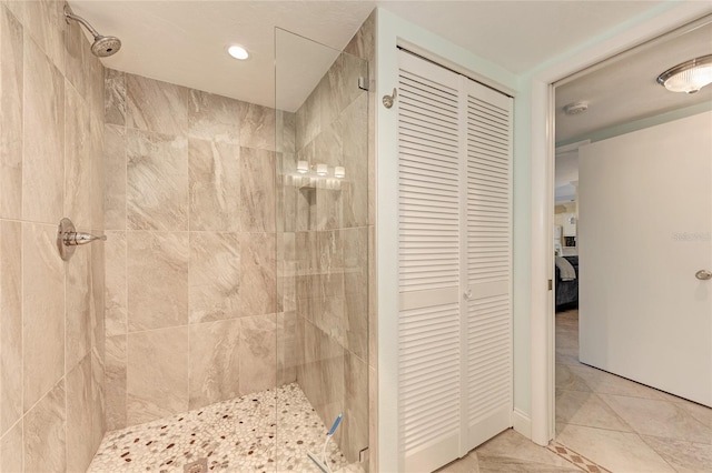 full bathroom with a stall shower, tile patterned flooring, and a closet