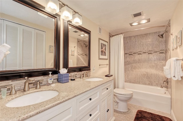 bathroom with shower / bathtub combination with curtain, visible vents, and a sink