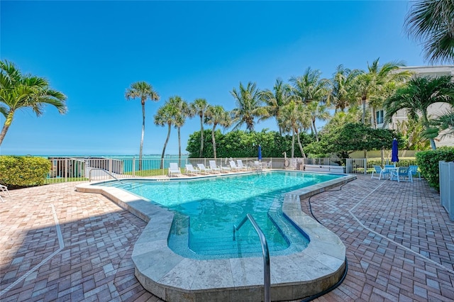 pool with fence and a patio