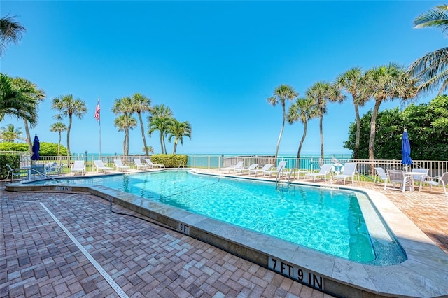 pool featuring fence and a patio