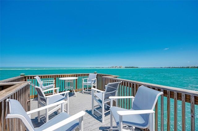 wooden terrace featuring a water view