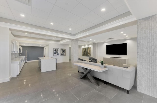 living area with crown molding, recessed lighting, a raised ceiling, tile patterned flooring, and baseboards