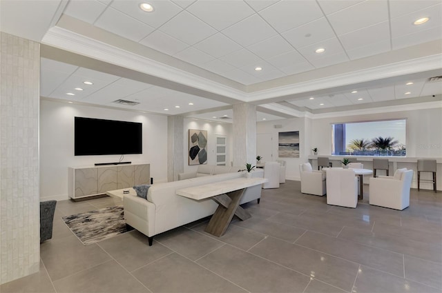 living room featuring crown molding, a tray ceiling, visible vents, and tile patterned floors