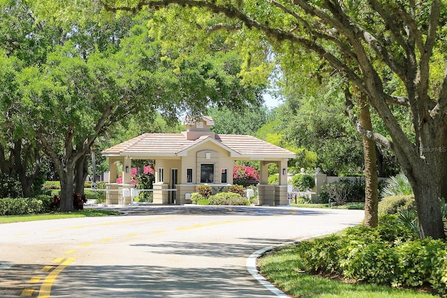 1654 Starling Dr Unit 201, Sarasota, FL 34231 - view of front of house featuring a tile roof and fence