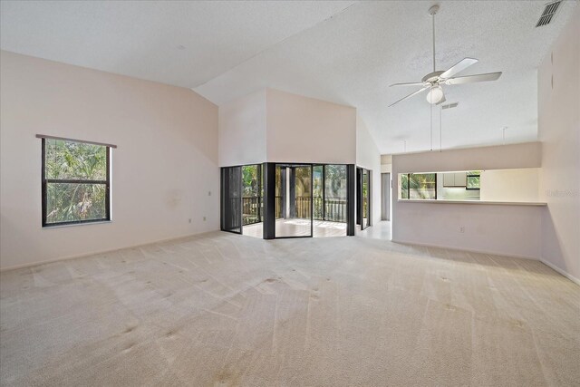 1654 Starling Dr Unit 201, Sarasota, FL 34231 - empty room with ceiling fan, high vaulted ceiling, carpet flooring, and a healthy amount of sunlight