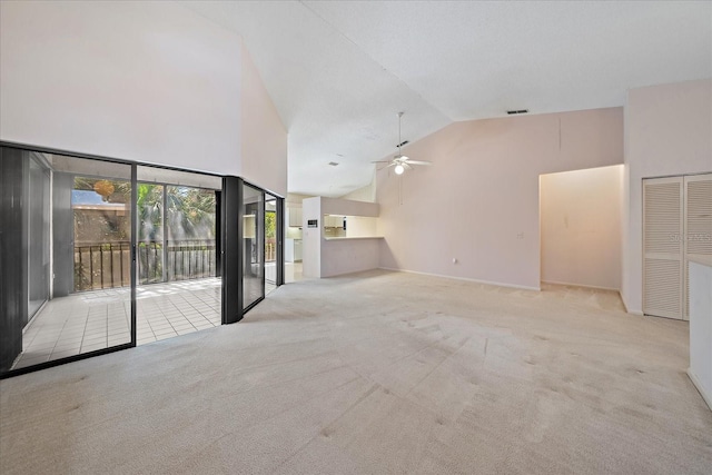 1654 Starling Dr Unit 201, Sarasota, FL 34231 - unfurnished living room with carpet, visible vents, high vaulted ceiling, and a ceiling fan