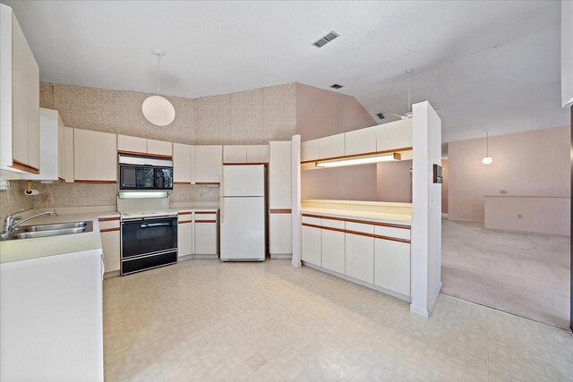 1654 Starling Dr Unit 201, Sarasota, FL 34231 - kitchen with range with electric stovetop, light floors, stainless steel microwave, freestanding refrigerator, and a sink