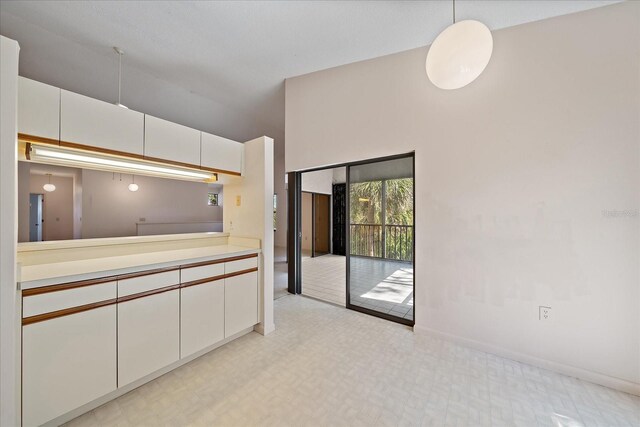 1654 Starling Dr Unit 201, Sarasota, FL 34231 - kitchen with light countertops, white cabinets, and light floors