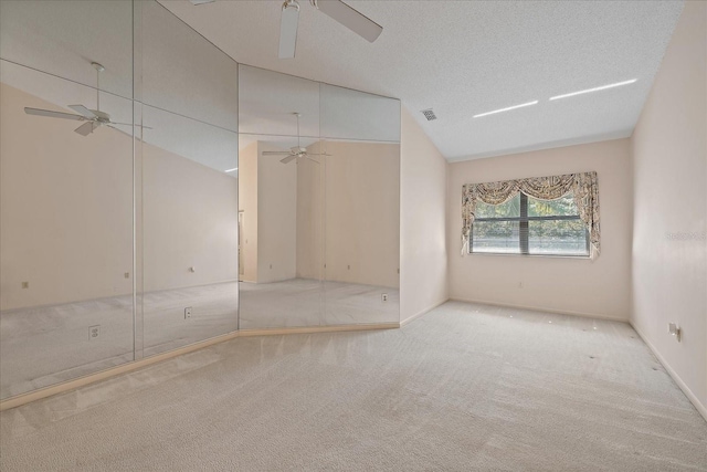 1654 Starling Dr Unit 201, Sarasota, FL 34231 - unfurnished bedroom with visible vents, lofted ceiling, ceiling fan, a textured ceiling, and carpet floors