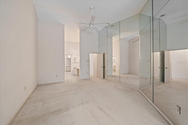 1654 Starling Dr Unit 201, Sarasota, FL 34231 - unfurnished bedroom featuring high vaulted ceiling, connected bathroom, light carpet, visible vents, and a ceiling fan