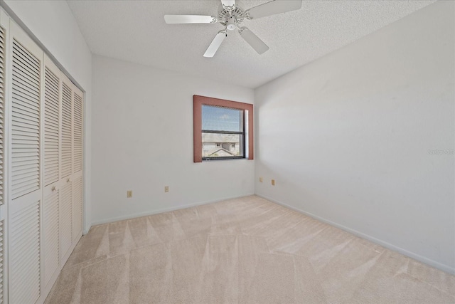 1654 Starling Dr Unit 201, Sarasota, FL 34231 - unfurnished bedroom featuring baseboards, a ceiling fan, a textured ceiling, carpet flooring, and a closet