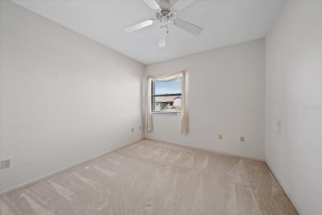 1654 Starling Dr Unit 201, Sarasota, FL 34231 - spare room featuring a textured ceiling, carpet flooring, and a ceiling fan