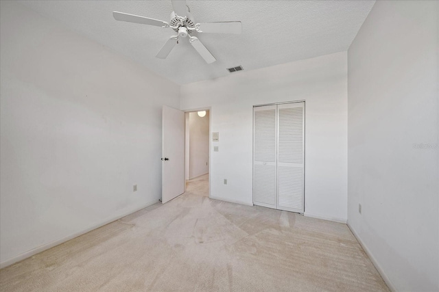 1654 Starling Dr Unit 201, Sarasota, FL 34231 - unfurnished bedroom featuring a textured ceiling, ceiling fan, visible vents, a closet, and carpet