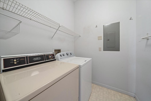 1654 Starling Dr Unit 201, Sarasota, FL 34231 - washroom featuring laundry area, baseboards, washer and dryer, electric panel, and light floors
