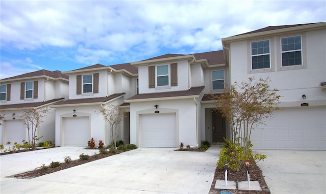 townhome / multi-family property featuring a garage