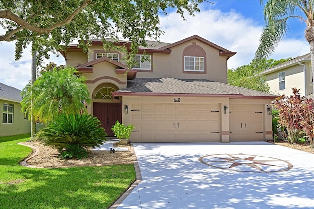 mediterranean / spanish-style home with a front lawn and a garage