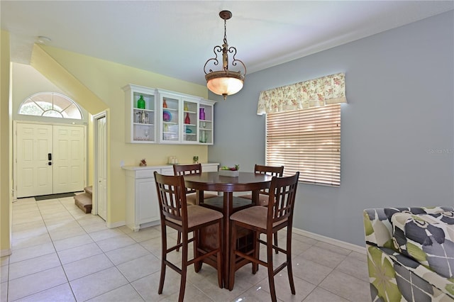 dining space featuring light tile patterned flooring