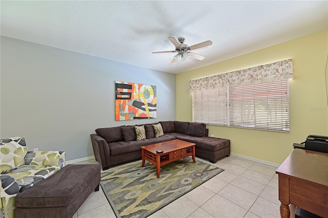 tiled living room with ceiling fan and a textured ceiling