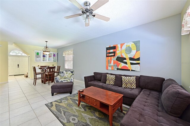 tiled living room with ceiling fan