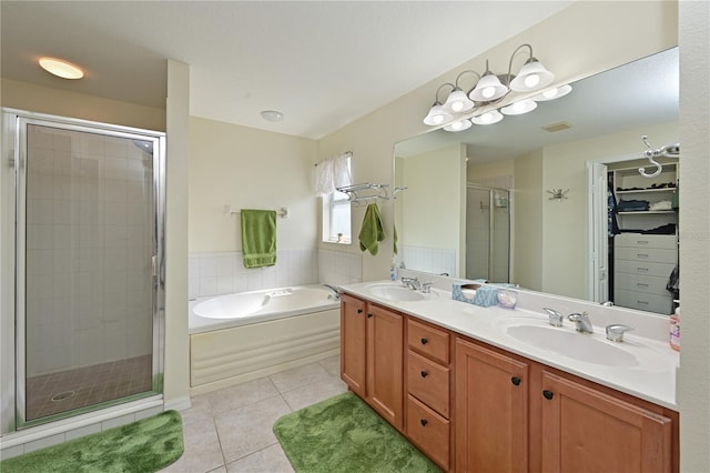 bathroom with tile patterned floors, vanity, and independent shower and bath