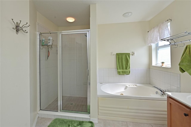 bathroom with tile patterned flooring, vanity, and plus walk in shower