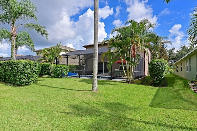 view of yard featuring a lanai and a swimming pool