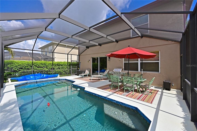 view of pool with a patio and a lanai