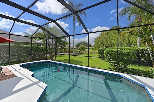 view of swimming pool featuring glass enclosure and a patio area