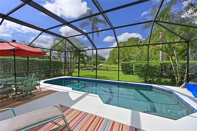 view of swimming pool with a lawn, a lanai, and a patio