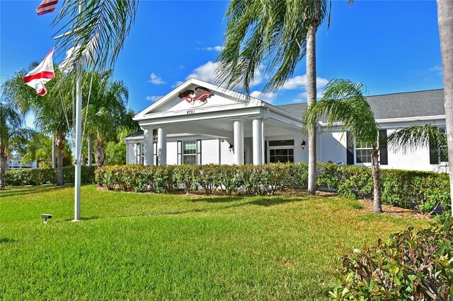 neoclassical home with a front yard