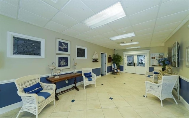 interior space featuring baseboards and a paneled ceiling