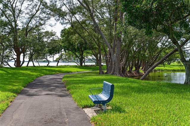 view of home's community featuring a lawn and a water view