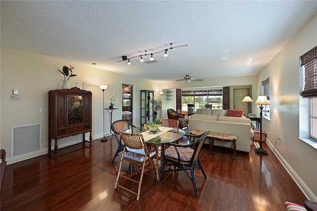 dining area featuring visible vents, baseboards, a textured ceiling, and hardwood / wood-style floors