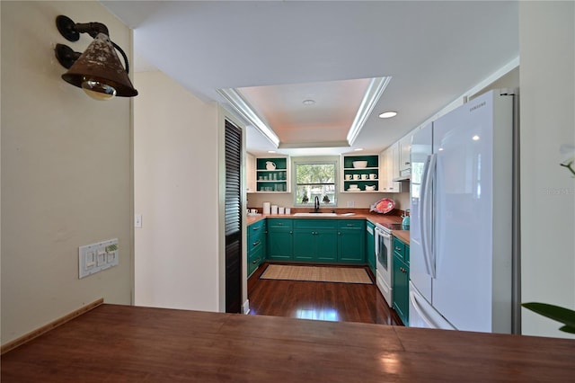 kitchen featuring a sink, green cabinets, a tray ceiling, white appliances, and open shelves