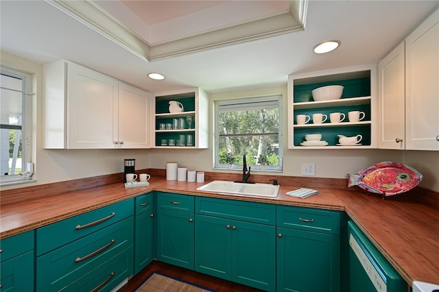 kitchen with a sink, wood counters, open shelves, white cabinets, and dishwashing machine