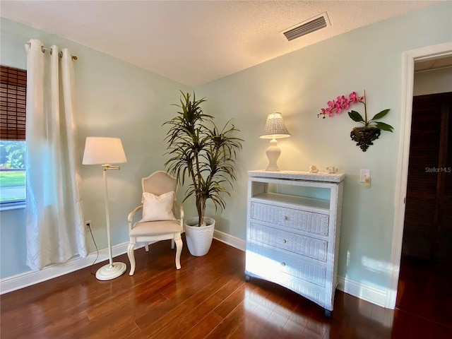 unfurnished room featuring visible vents, baseboards, and wood finished floors