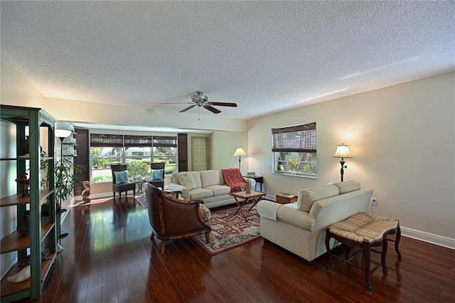 living area with baseboards, wood-type flooring, a textured ceiling, and ceiling fan