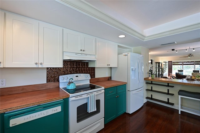 kitchen with butcher block countertops, under cabinet range hood, backsplash, white appliances, and white cabinets