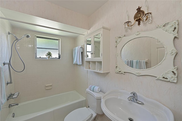 bathroom with a sink, toilet, and tub / shower combination