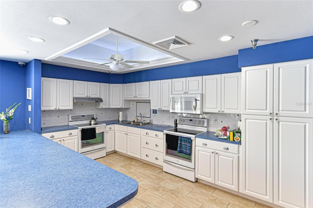 kitchen with electric range, stainless steel microwave, visible vents, and a sink