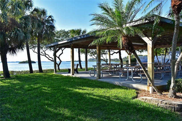 surrounding community featuring a gazebo, a lawn, and a water view