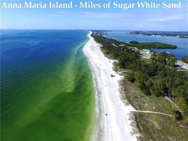 aerial view featuring a view of the beach and a water view