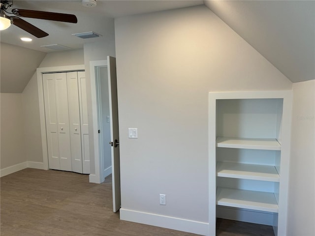 interior space with vaulted ceiling, light hardwood / wood-style floors, and ceiling fan