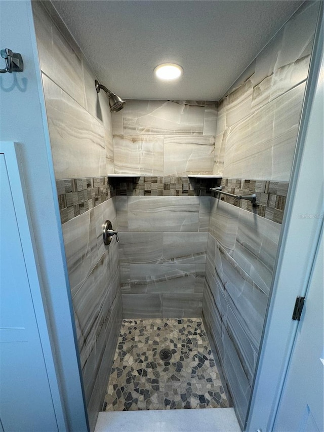 bathroom with tiled shower