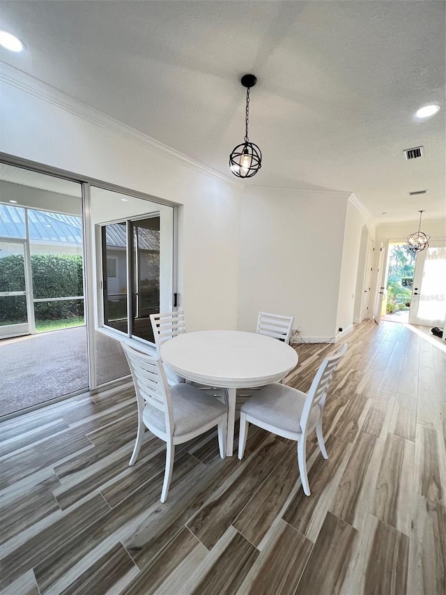 unfurnished dining area with an inviting chandelier and ornamental molding