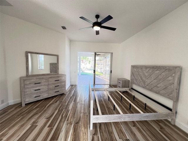 bedroom with access to outside, ceiling fan, and dark wood-type flooring